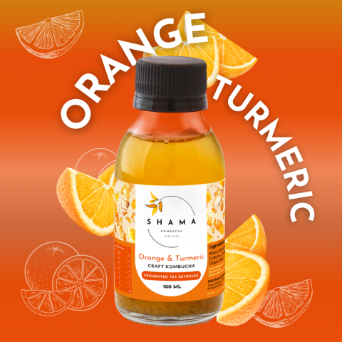 Bottle of Orange & Turmeric Kombucha with orange slices on an orange background